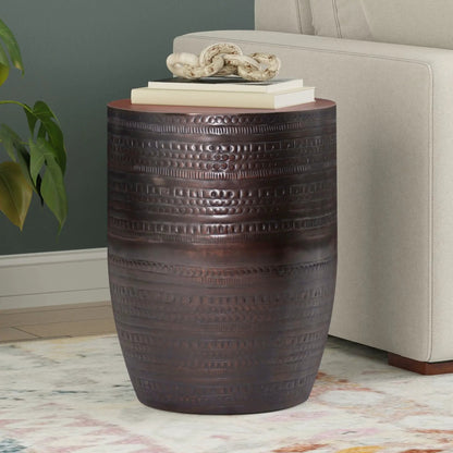 Johnsen Handcrafted Large Metal Accent Table with dark bronze drum texture and stacked books on Tampa Home & Garden Store