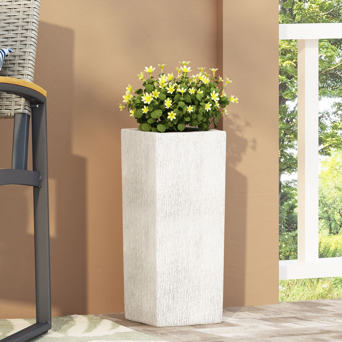 Modern Outdoor Planter by HouseOfZazla white textured tall planter with yellow blooms on patio on Tampa Home & Garden Store