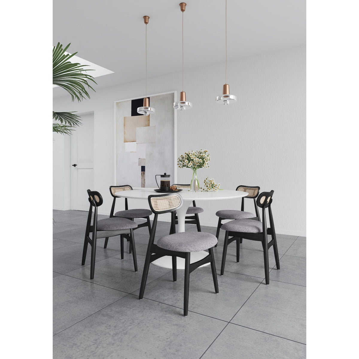 Dining chair set with cane backrests in black frames around a white round table on Tampa Home & Garden Store
