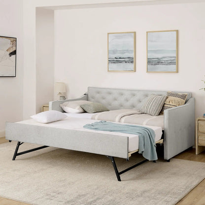 Gray upholstered daybed with pop-up trundle on black metal legs and decorative pillows on Tampa Home & Garden Store