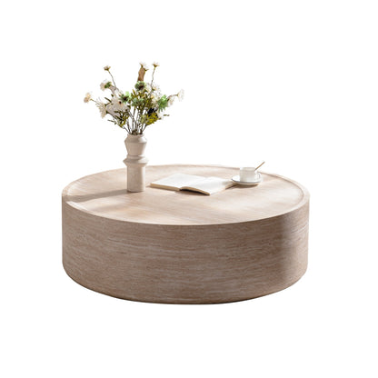 Round coffee table in light wood finish with Mars pattern; vase of white flowers on top on Tampa Home & Garden Store