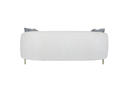 Rounded white stationary sofa with textured fabric and two blue patterned cushions, brass legs on Tampa Home & Garden Store