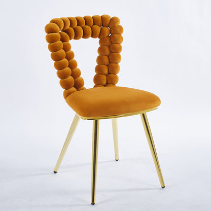 Modern chair with orange velvet bead-back cushions and gold iron tube legs on Tampa Home & Garden Store