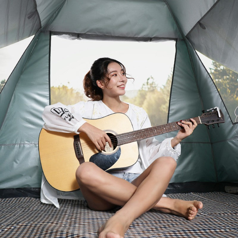 Tent camping scene with a woman inside a green camping tent playing an acoustic guitar on Tampa Home & Garden Store