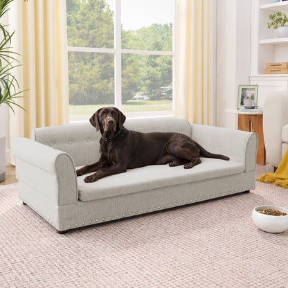 Oversized pet sofa in gray linen, tufted cushion with nailhead trim, dog resting indoors on Tampa Home & Garden Store