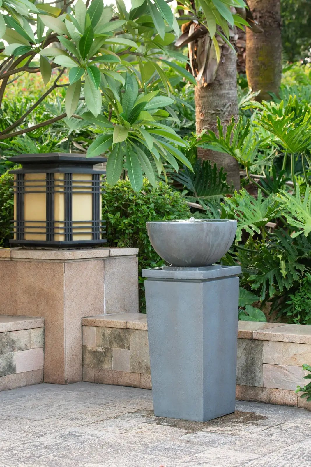 Zen Bowl Water Fountain on gray concrete pedestal in a lush garden setting on Tampa Home & Garden Store