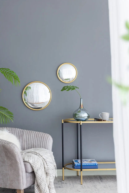 Three gold round wall mirrors with iron frames on a gray wall by Unique Piece Furniture on Tampa Home & Garden Store