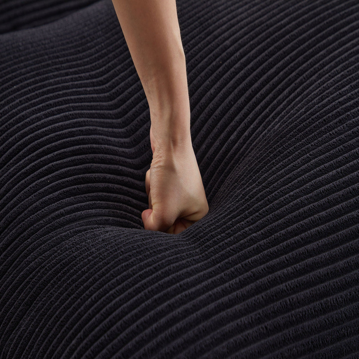 Modern deep seat sectional sofa with ottoman fabric close-up in dark charcoal corduroy on Tampa Home & Garden Store