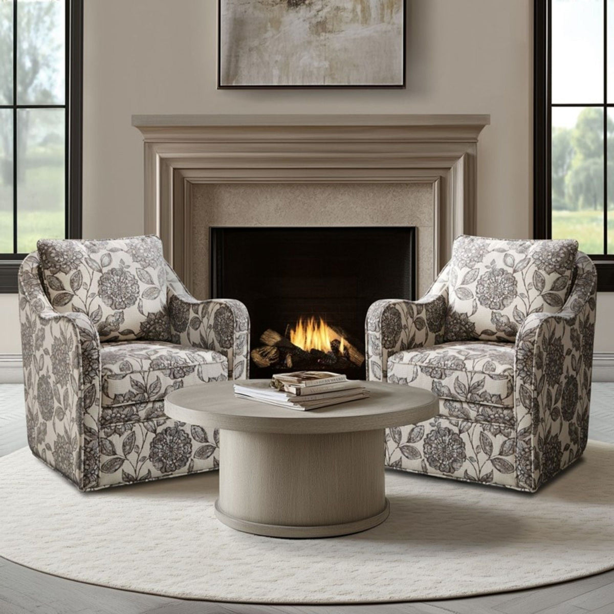 Pair of swivel arm chairs in gray floral upholstery around a round pedestal table by a fireplace on Tampa Home & Garden Store