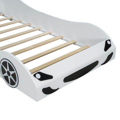 Race car shaped platform bed white finish with wood slat base and bold wheel graphics on Tampa Home & Garden Store