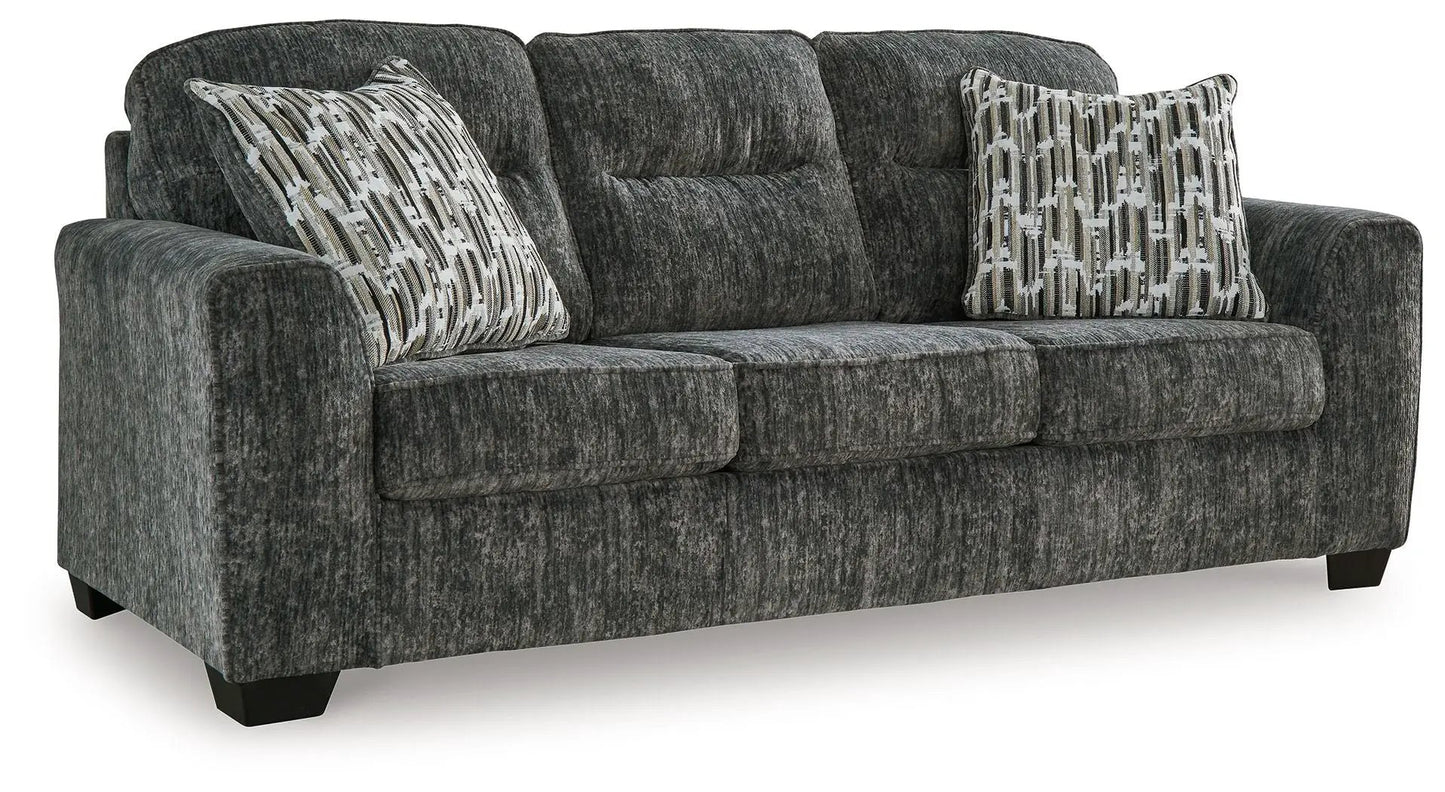 Lonoke stationary sofa in dark charcoal textured fabric with two patterned throw pillows on Tampa Home & Garden Store