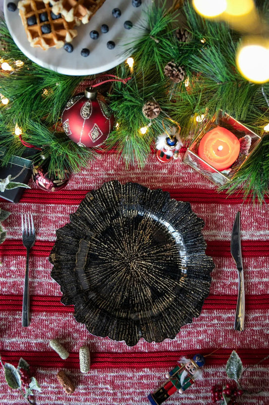 Plastic charger plate set of 8, black textured sunburst design on red holiday table on Tampa Home & Garden Store