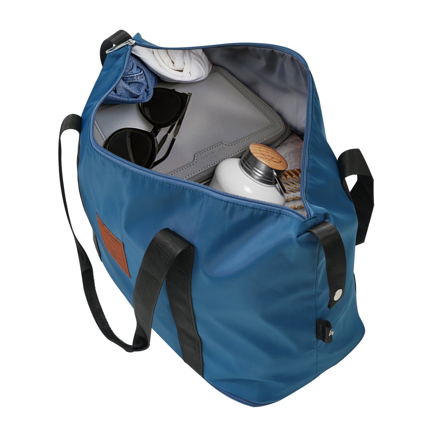 Blue luggage bag opened to reveal sunglasses, wallet, towel and bottle inside on Tampa Home & Garden Store