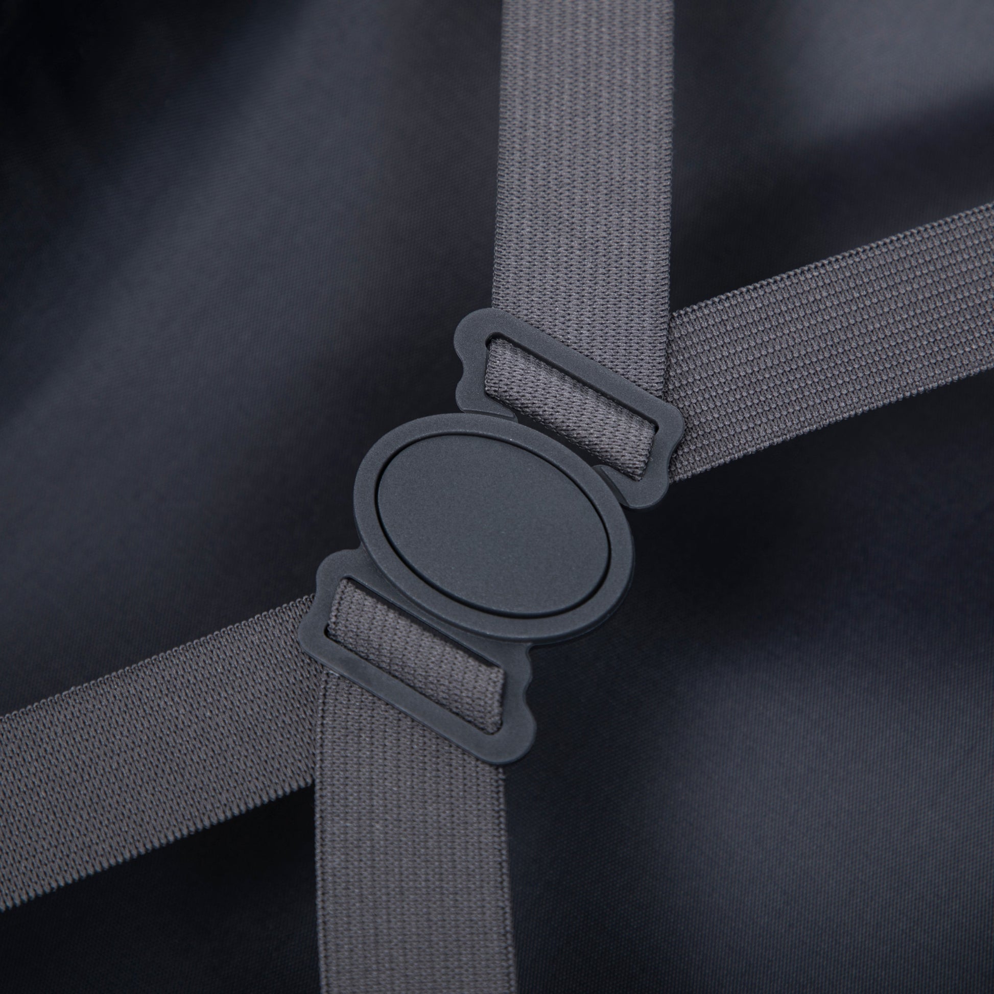 Luggage strap close-up in gray webbing with black buckle on dark fabric on Tampa Home & Garden Store