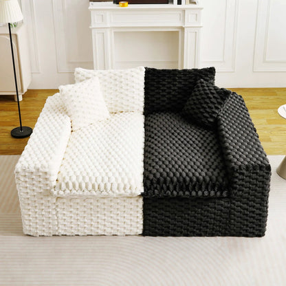 Luxury stationary sofa with white and black chunky-knit throws in a bright living room on Tampa Home & Garden Store