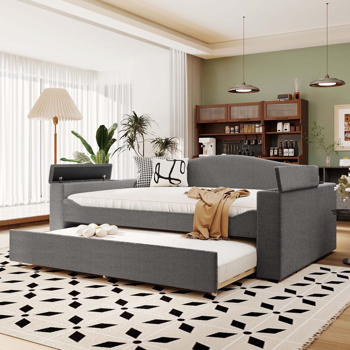 Upholstered gray daybed with storage armrests and pull-out trundle in a modern living room on Tampa Home & Garden Store