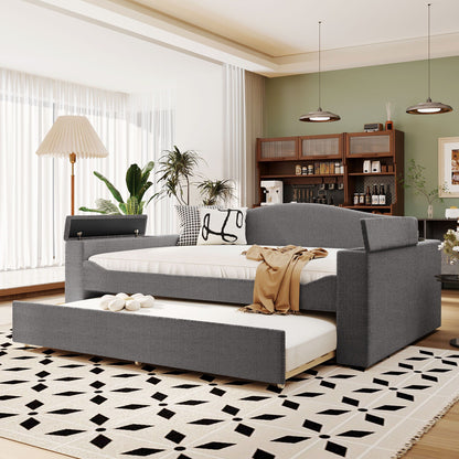 Upholstered gray daybed with storage armrests and pull-out trundle in a modern living room on Tampa Home & Garden Store