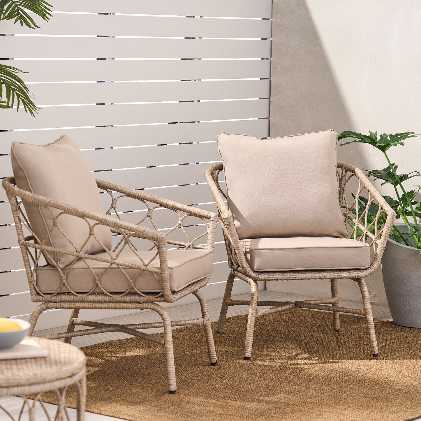 Bruce Outdoor Club Chair Set with water resistant cushions, two beige wicker chairs on a rug on Tampa Home & Garden Store