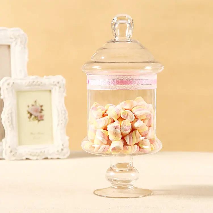 Clear glass candy jar with lid on a pedestal, filled with pastel marshmallows and pink ribbon on Tampa Home & Garden Store