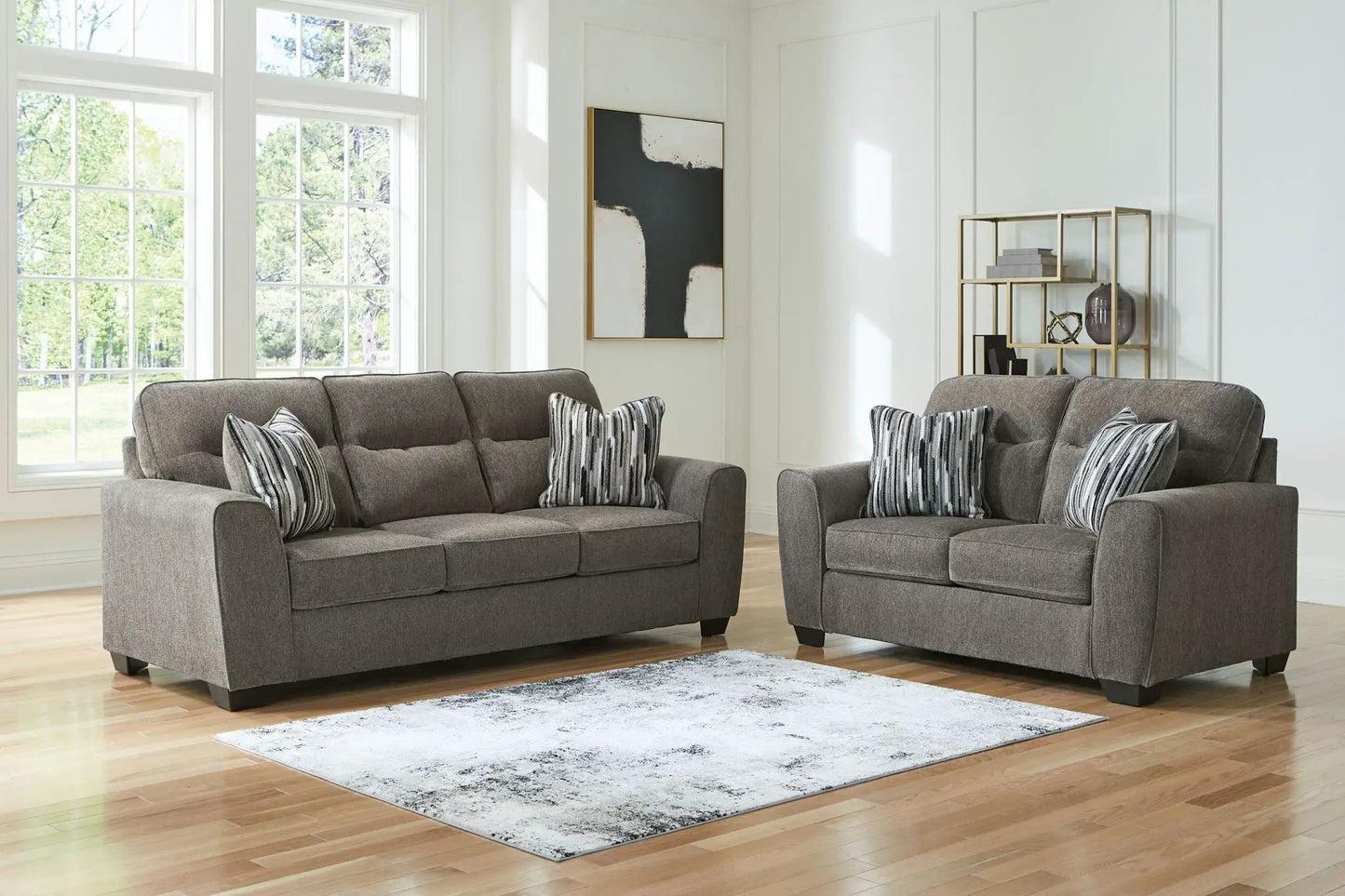 Olten living room set in gray fabric with two plush sofas and striped throw pillows on Tampa Home & Garden Store