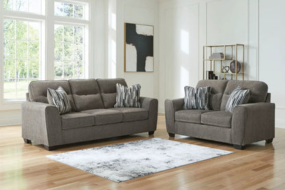 Olten living room set in gray fabric with two plush sofas and striped throw pillows on Tampa Home & Garden Store