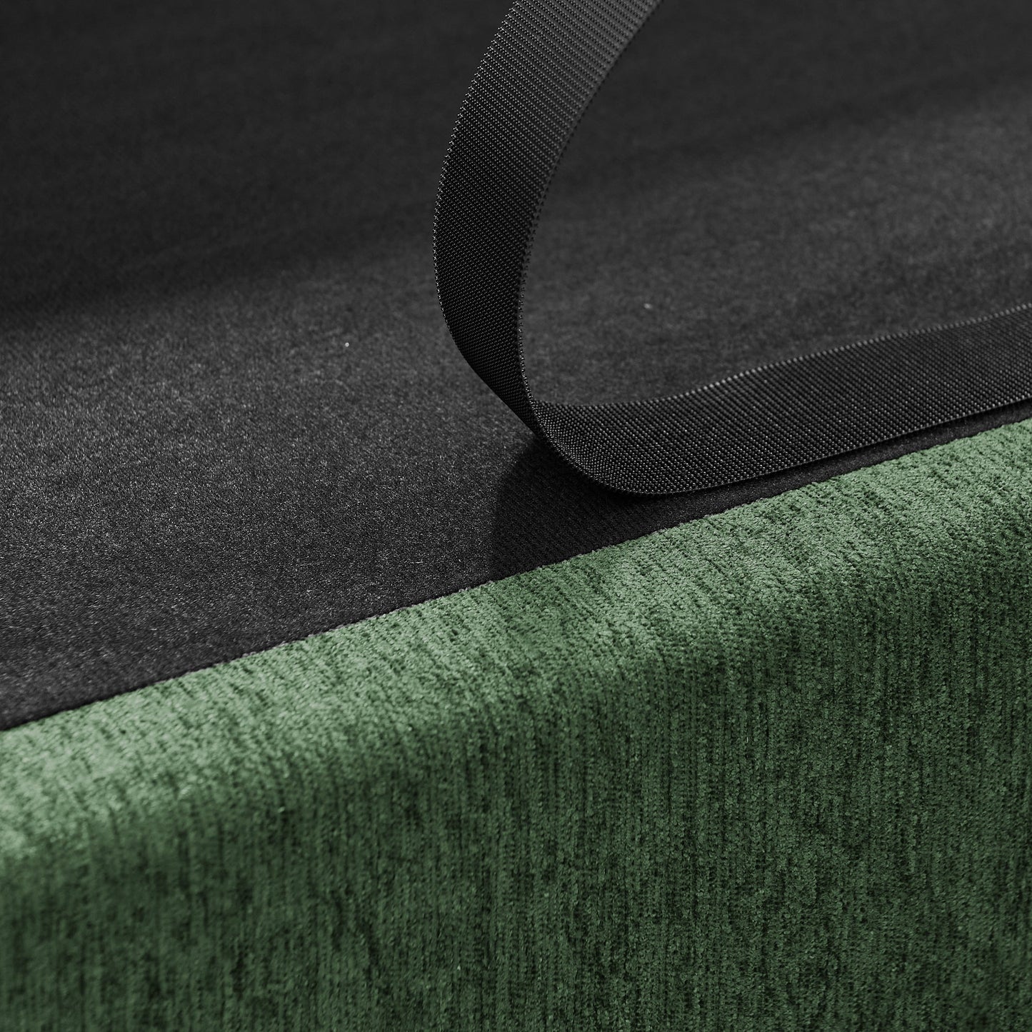 Oversized Pet Sofa strap detail, black nylon webbing curves over dark fabric with green trim on Tampa Home & Garden Store