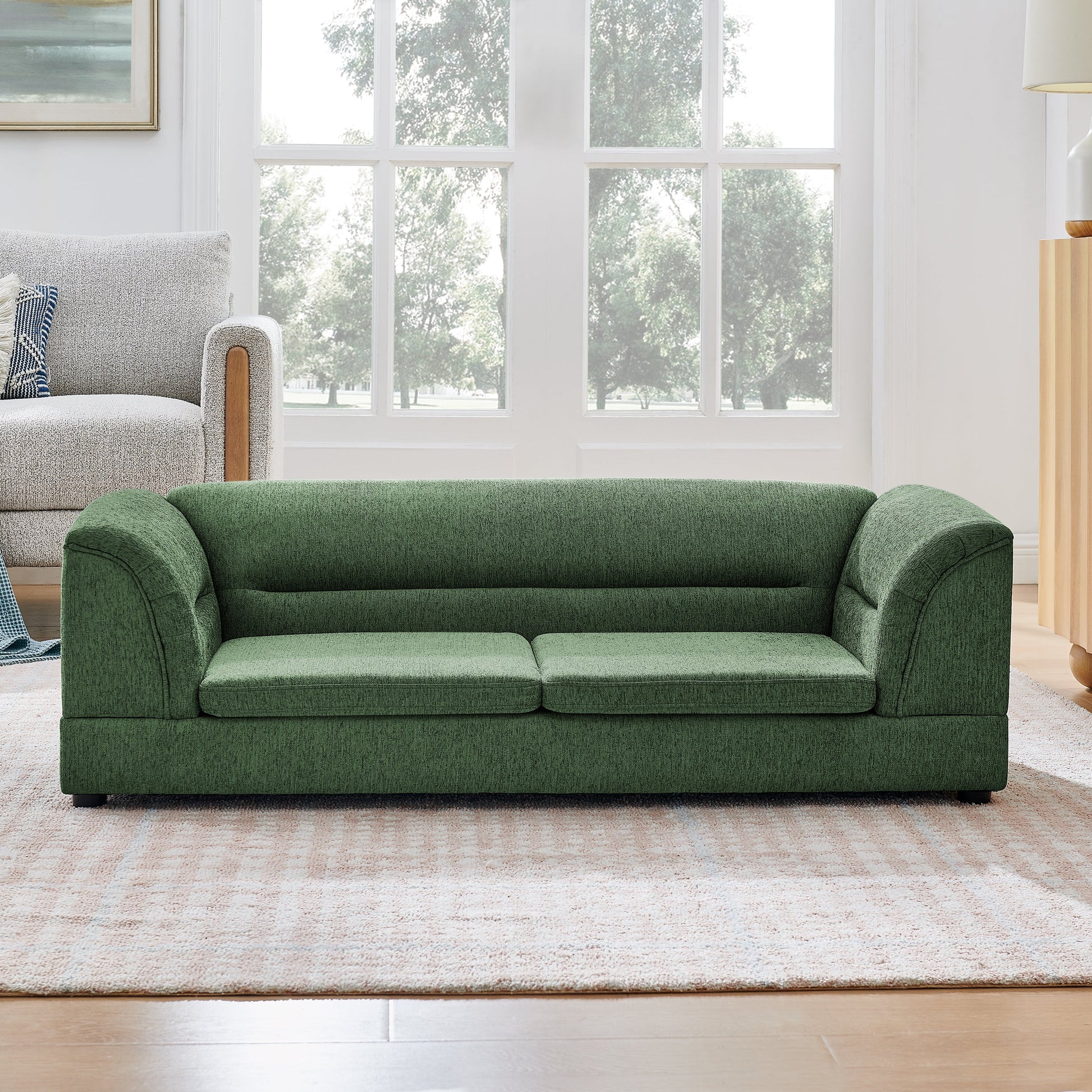 Oversized pet sofa with curved armrests in green upholstery, two sofas in living room on Tampa Home & Garden Store