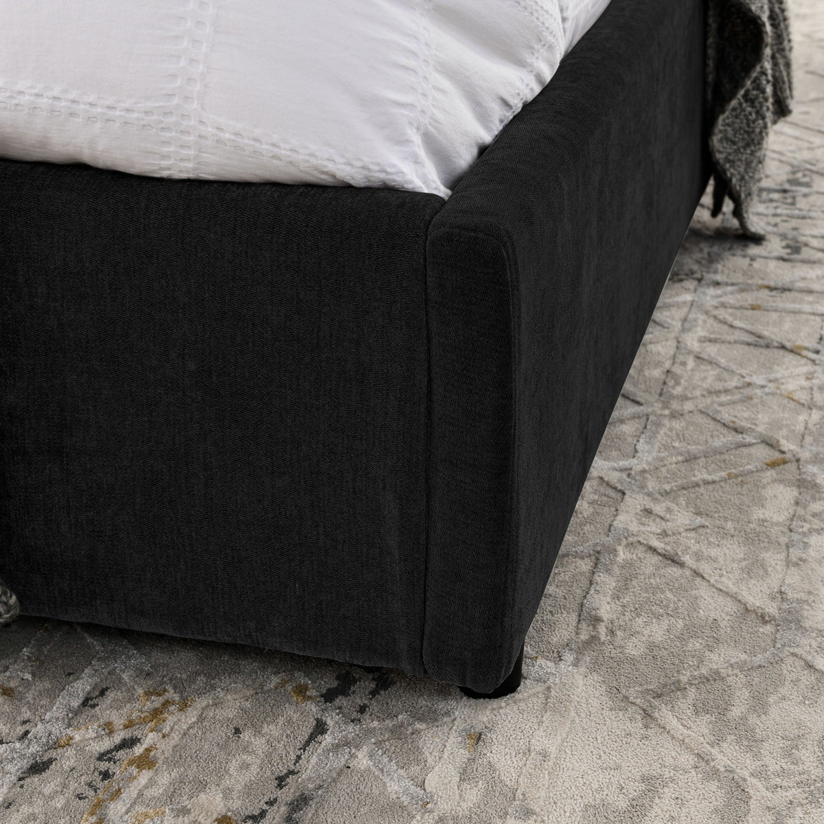 Storage upholstered platform bed with integrated headboard, black fabric with white bedding on Tampa Home & Garden Store
