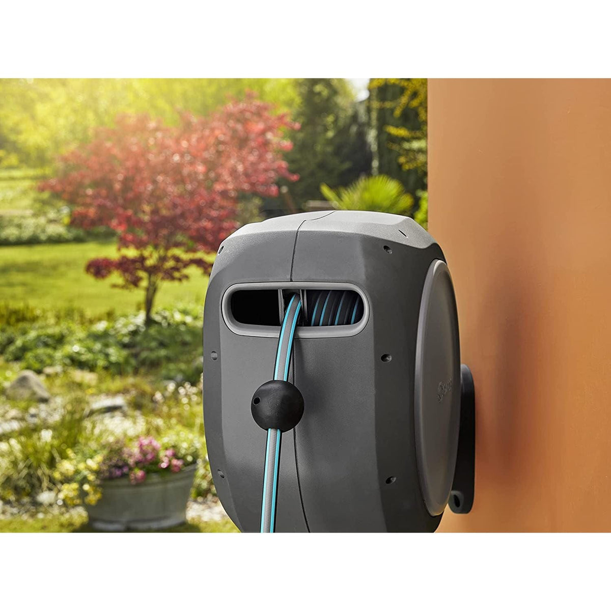 Retractable Hose Reel RollUp 75 ft auto retracting by Gardena, gray wall-mounted with blue hose on Tampa Home & Garden Store