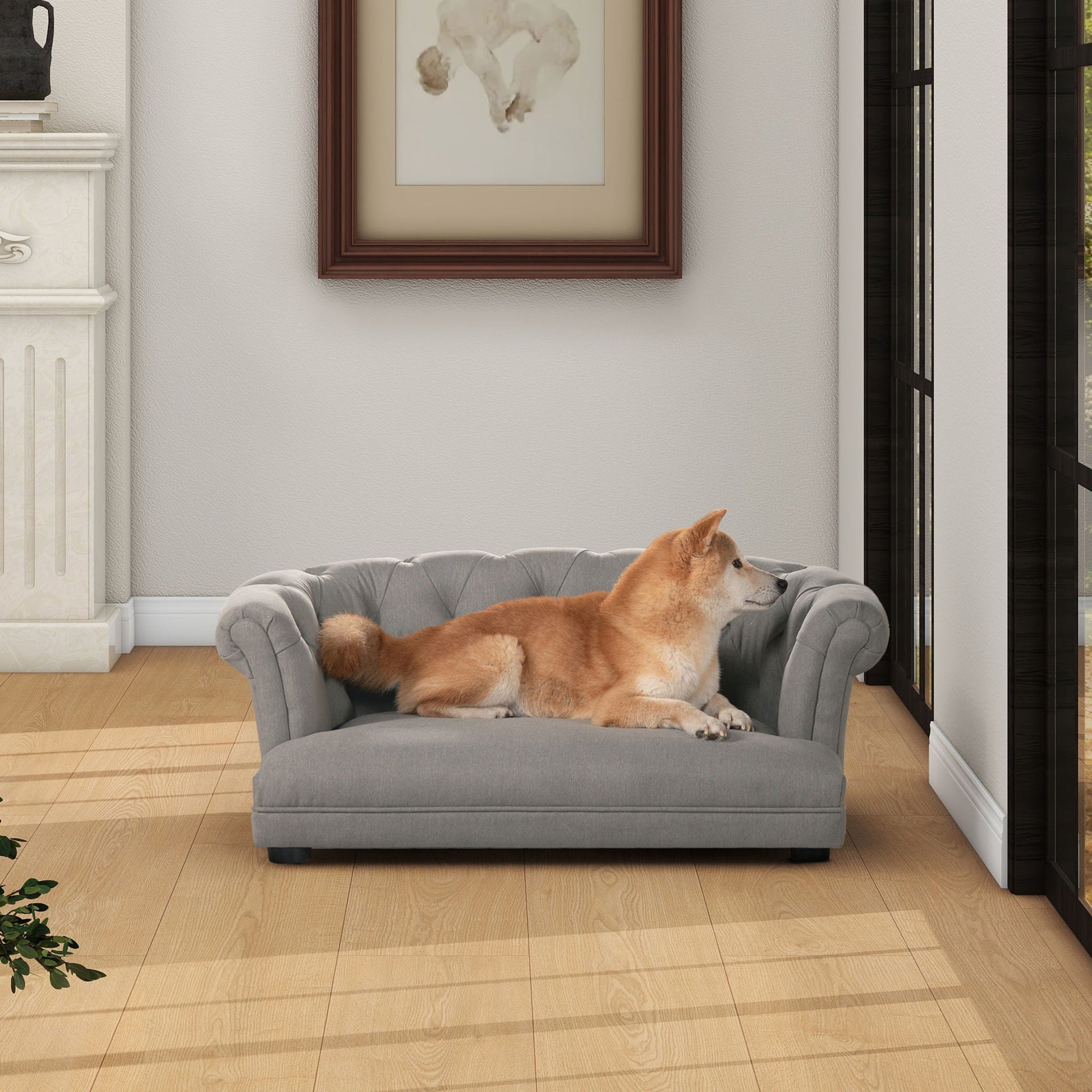 Kiki Chesterfield Dog Sofa Bed, medium gray tufted fabric with plush cushion, dog resting on it on Tampa Home & Garden Store