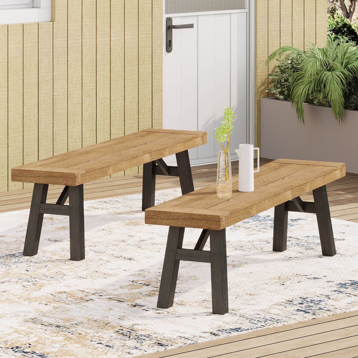 Two outdoor benches with slat panel design and acacia wood frames on a wooden deck on Tampa Home & Garden Store