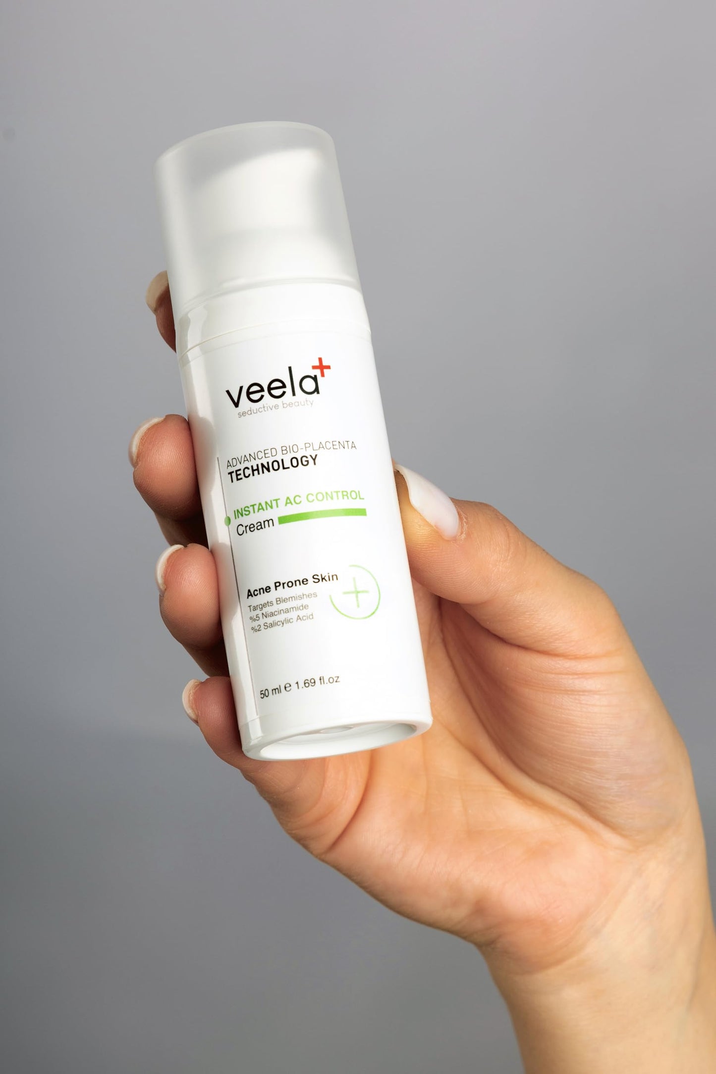 Veela+ Acne Control Cream bottle held in hand, white pump bottle with green accent label Acne Prone Skin 50 ml on Tampa Home & Garden Store