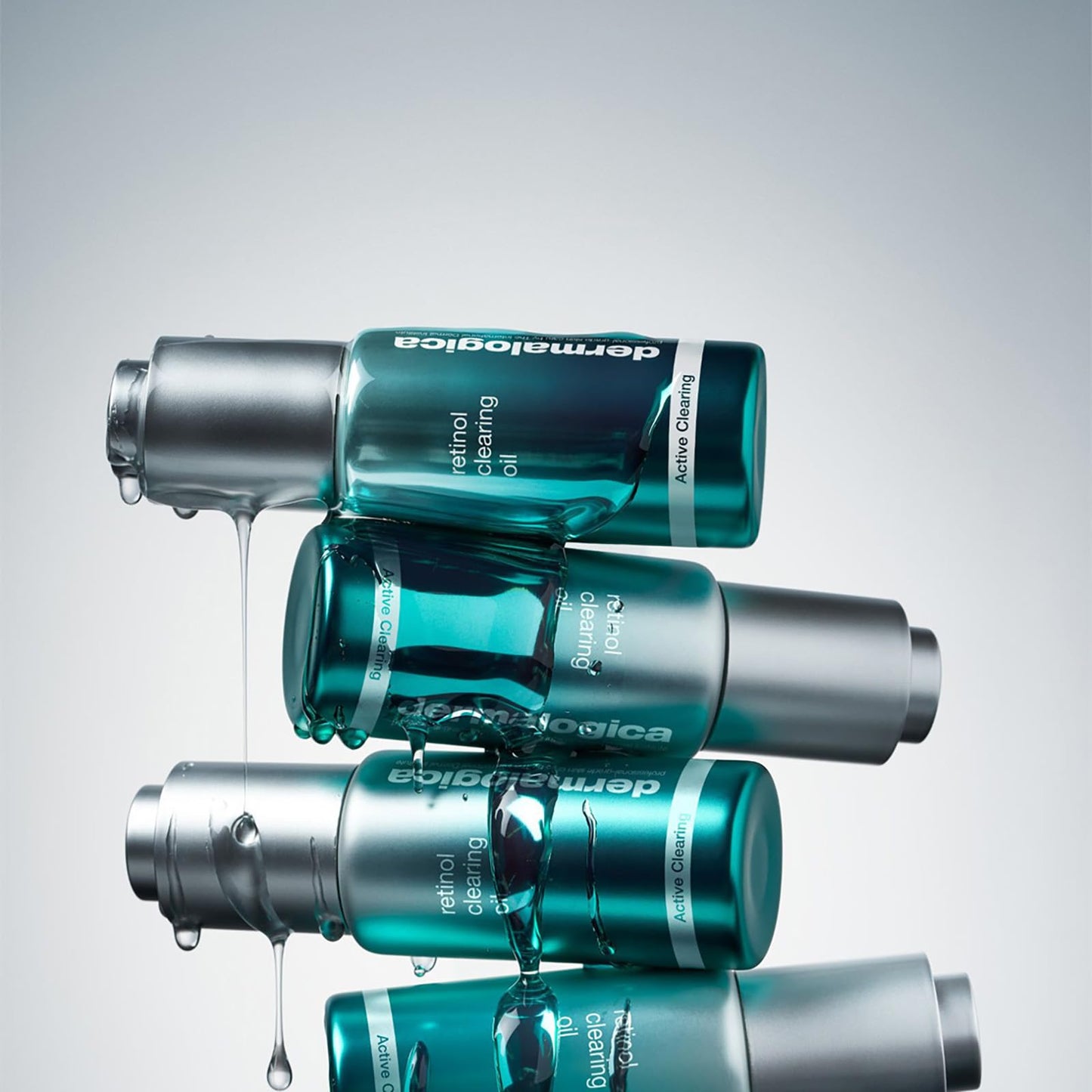 Dermalogica retinol clearing oil bottles in teal glass with silver caps, droplets dripping on Tampa Home & Garden Store