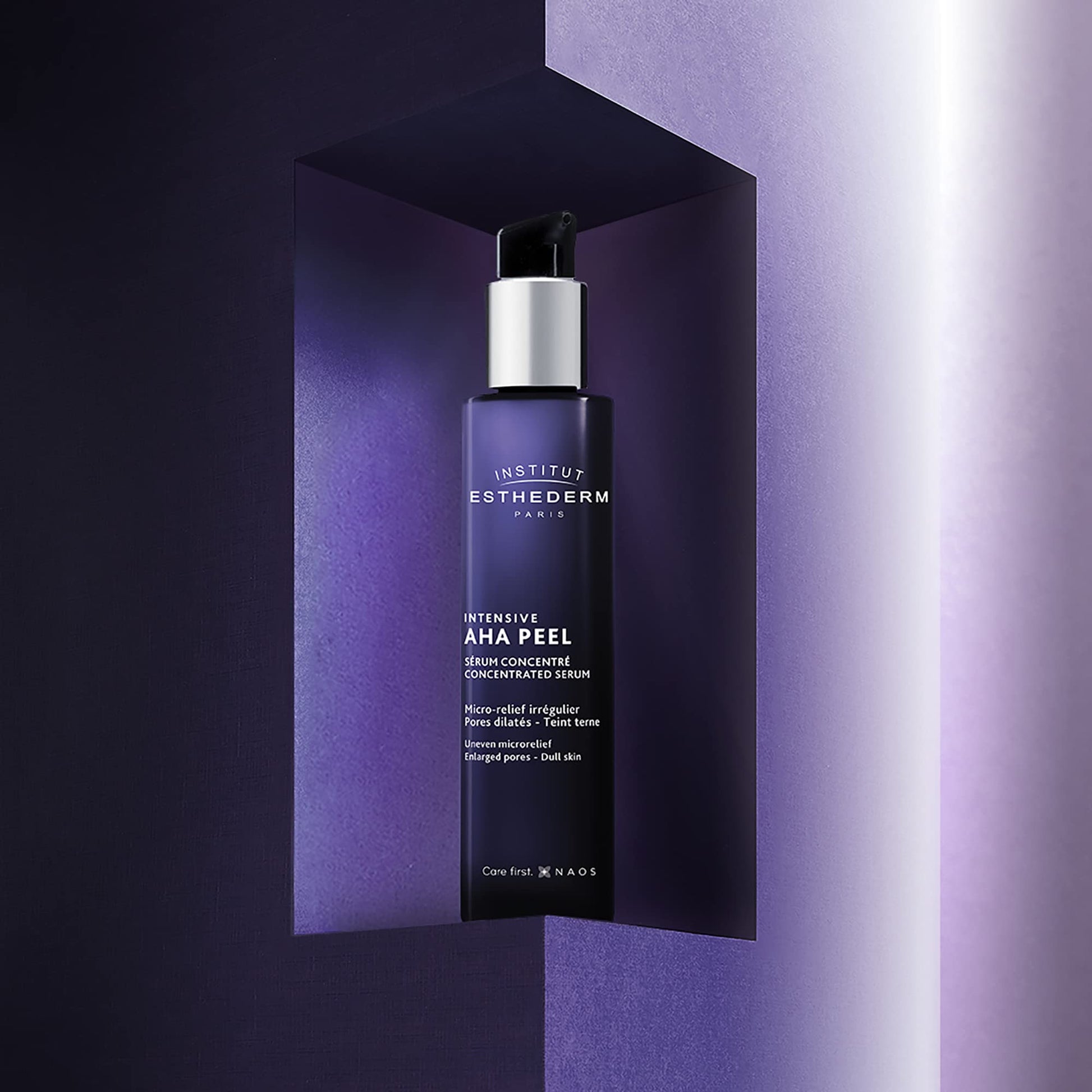 Institut Esthederm AHA Peel Intensive Serum bottle with pump against a purple backdrop on Tampa Home & Garden Store