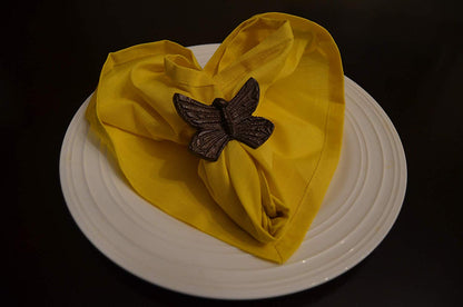 Vibhsa aluminum butterfly napkin ring on a bright yellow folded napkin over a white plate on Tampa Home & Garden Store