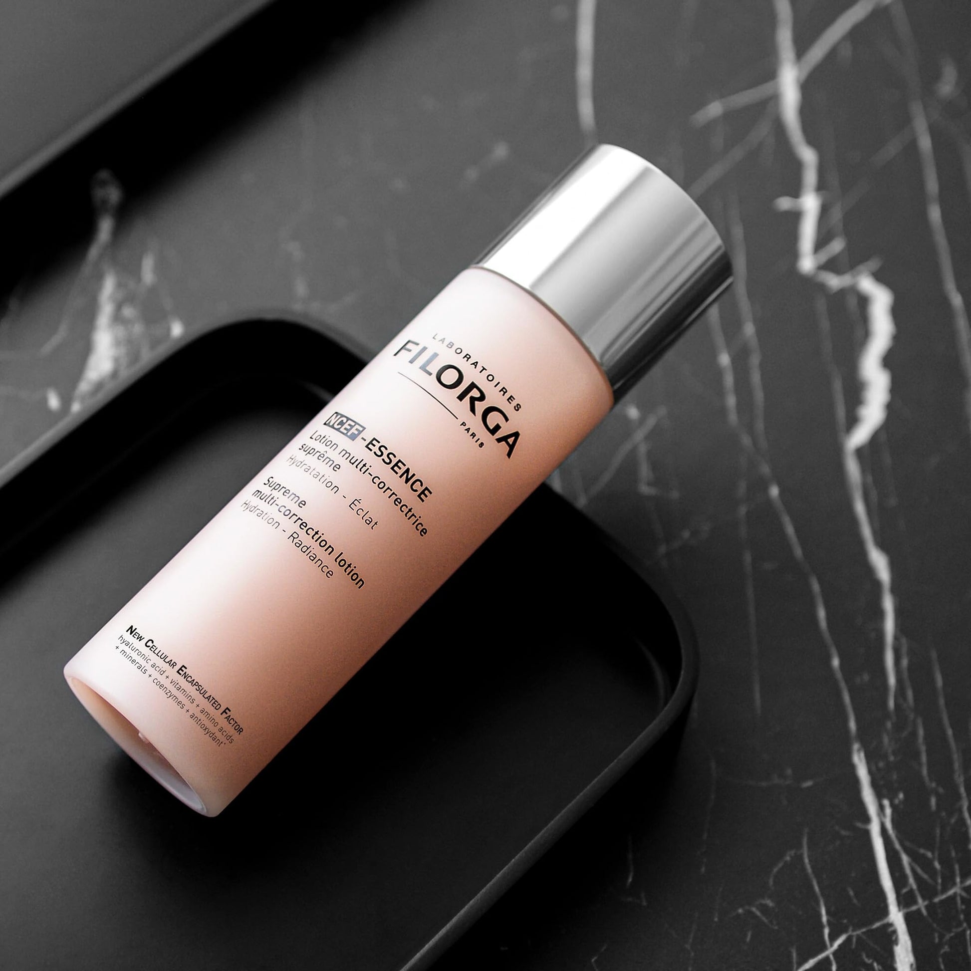 Filorga NCTF Essence Supreme regenerating lotion bottle with pink gradient and silver cap on Tampa Home & Garden Store