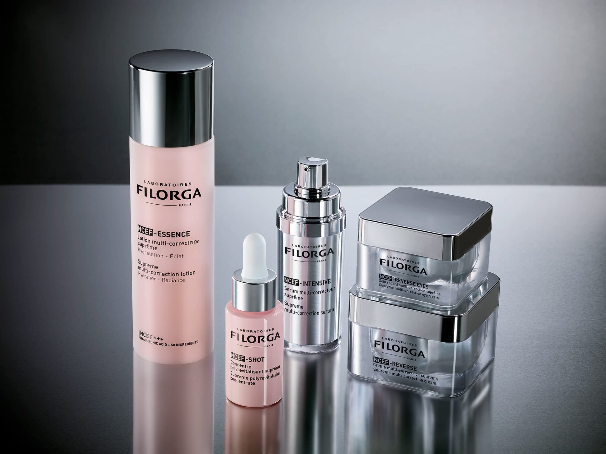 Filorga NCTF Essence Supreme regenerating lotion in pink bottle with chrome cap beside Filorga serums on Tampa Home & Garden Store