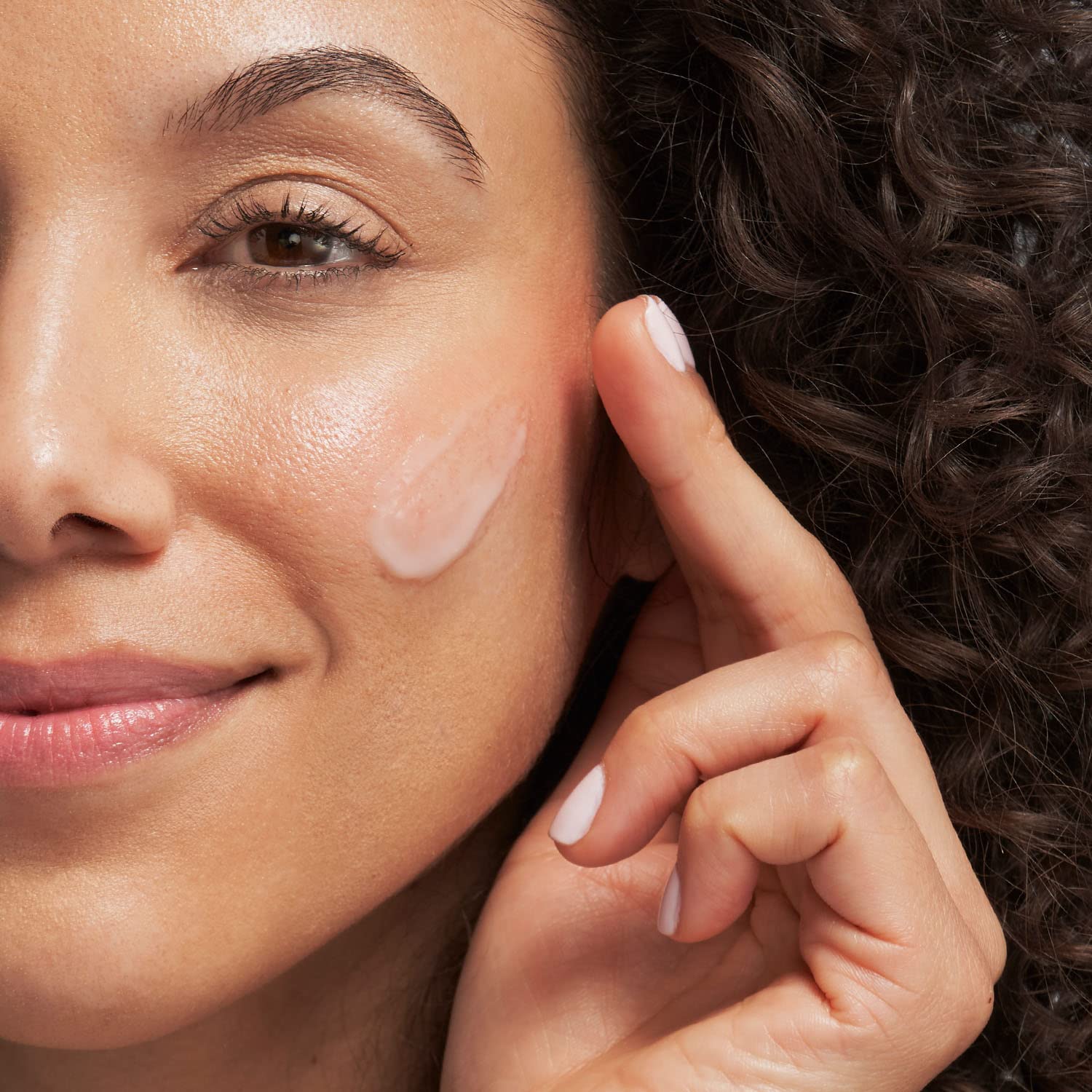 Face serum on cheek; pale pink mandelic acid mattifying serum applied with fingertip on Tampa Home & Garden Store