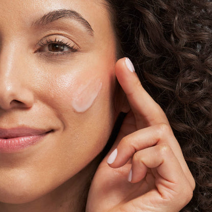 Face serum on cheek; pale pink mandelic acid mattifying serum applied with fingertip on Tampa Home & Garden Store