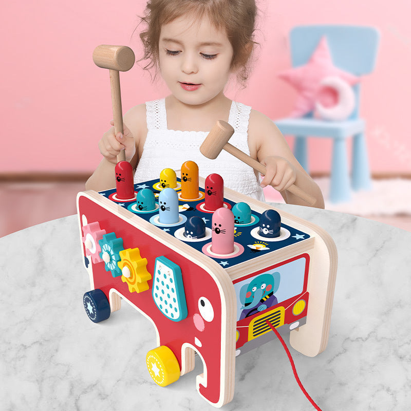 Montessori wooden pounding bench for toddlers with colorful pegs and two hammers, bus panels on Tampa Home & Garden Store