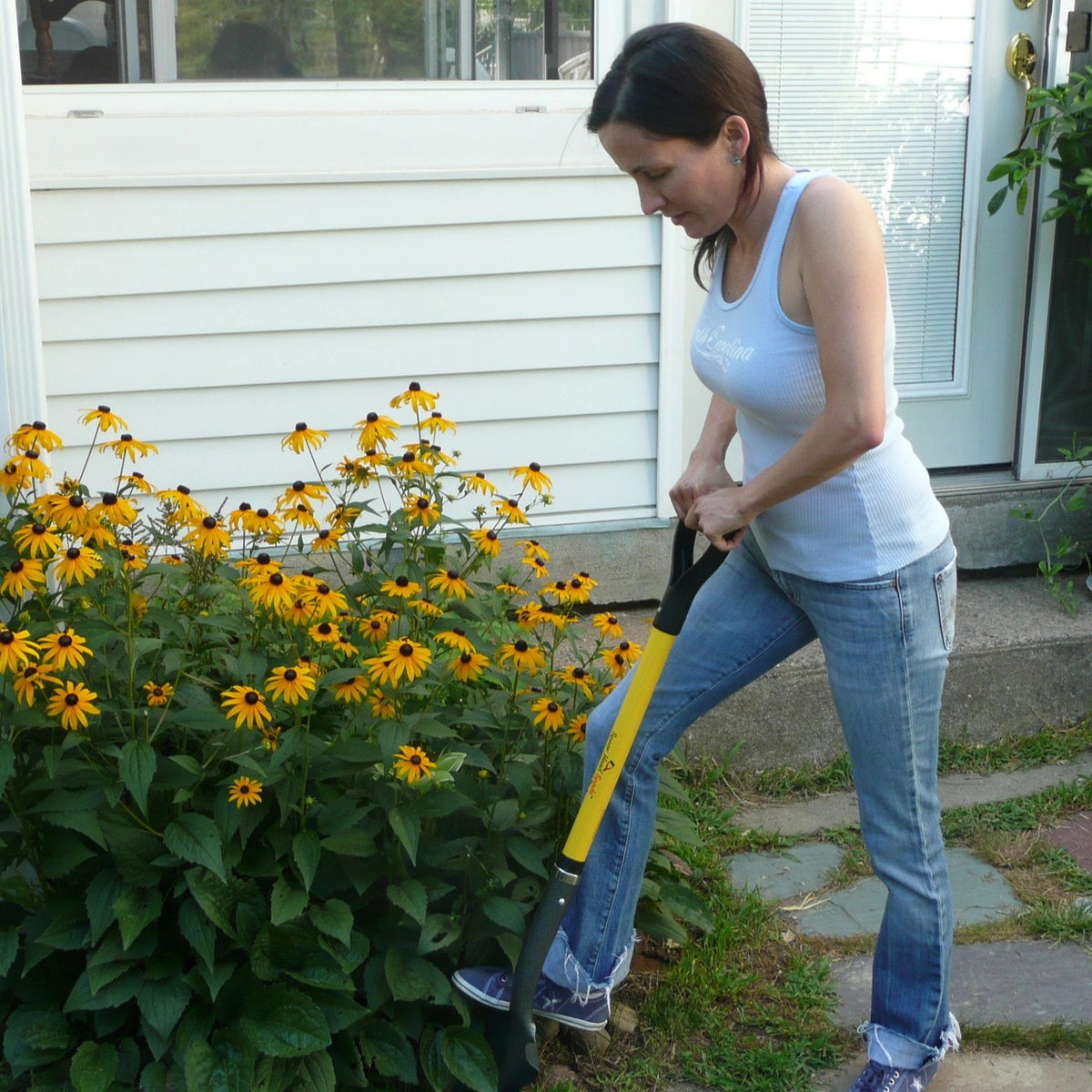 Spear Head Spade 40in D-grip yellow shaft black handle in use by a woman digging a flower bed on Tampa Home & Garden Store