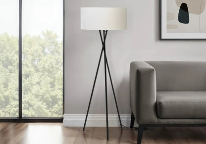 Floor lamp black tripod with white drum shade beside gray sofa in modern living room on Tampa Home & Garden Store
