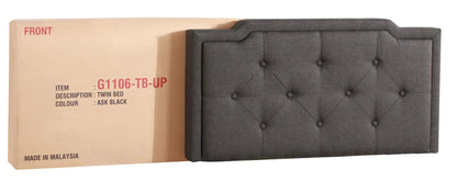 Twin button-tufted upholstered bed in dark gray fabric with diamond tufting beside a packing box on Tampa Home & Garden Store