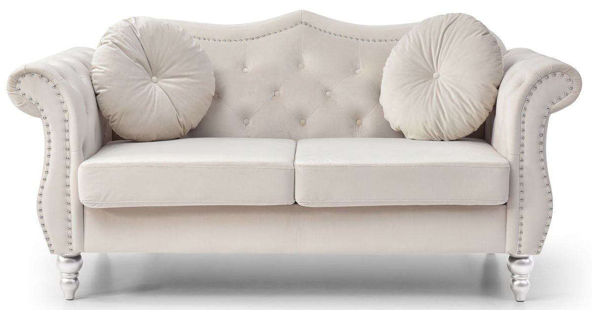 Beige tufted loveseat with flared arms, nailhead trim, and bolster cushions on turned legs on Tampa Home & Garden Store