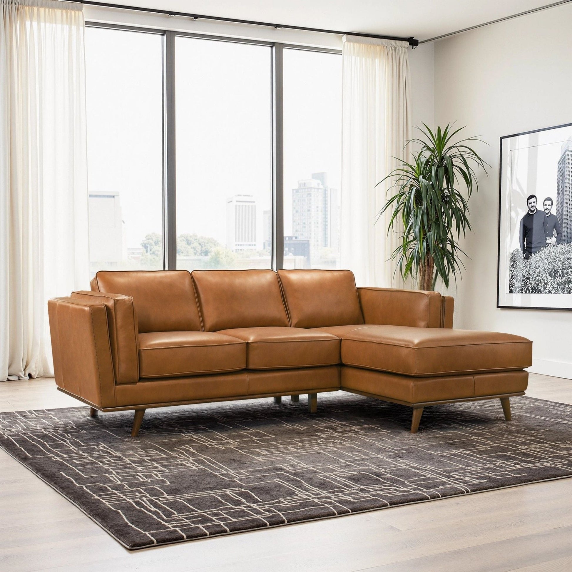 Chase Sectional Sofa by HouseOfZazla in tan leather with metal legs in a bright living room on Tampa Home & Garden Store