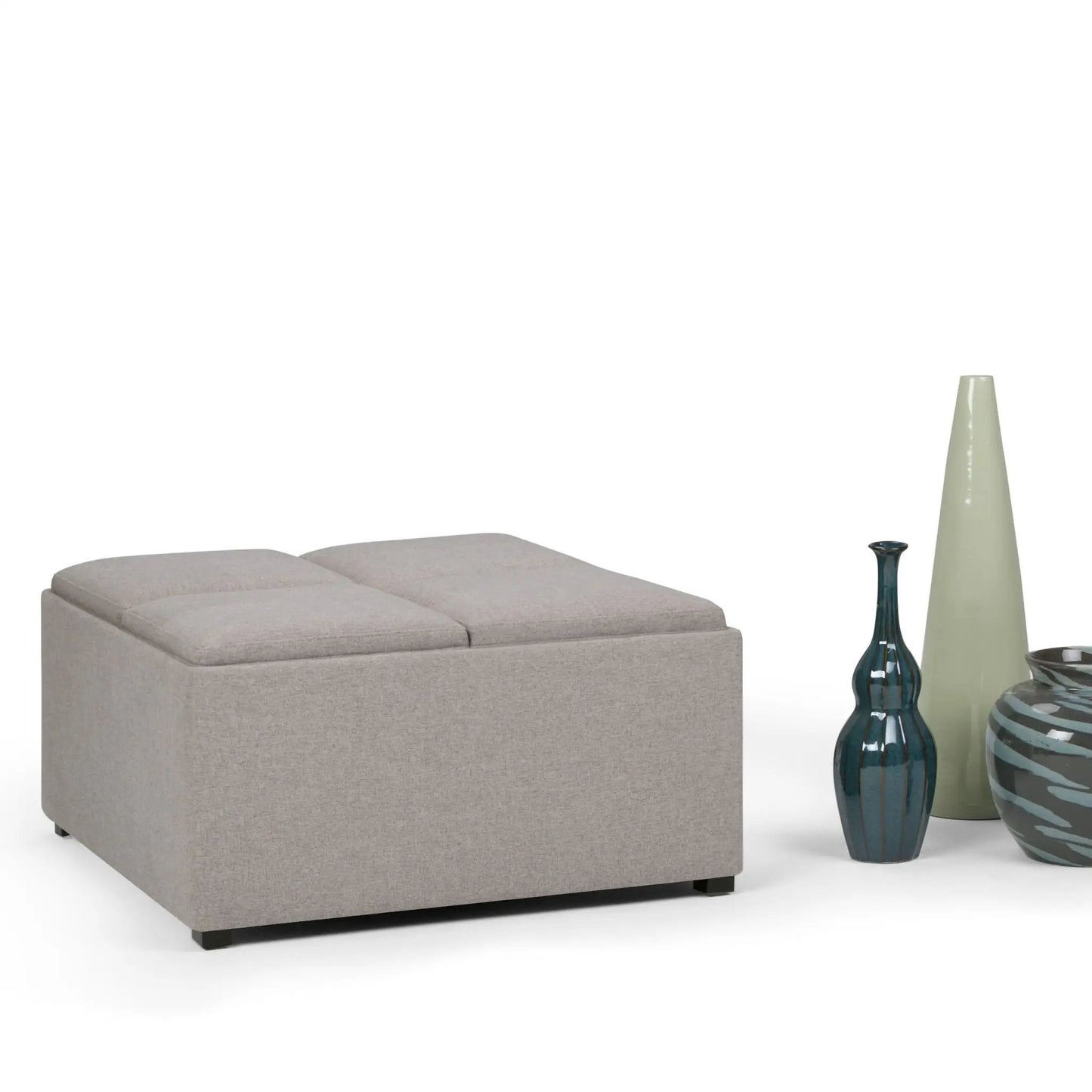 Avalon square storage ottoman in light gray fabric with decorative vases nearby on Tampa Home & Garden Store