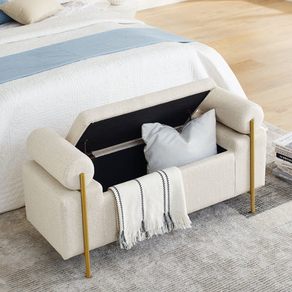 Elegant upholstered storage bench with cylindrical arms and gold iron legs in tan fabric at foot on Tampa Home & Garden Store