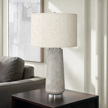 Table lamp gray resin base with beige linen shade on dark wood side table on Tampa Home & Garden Store