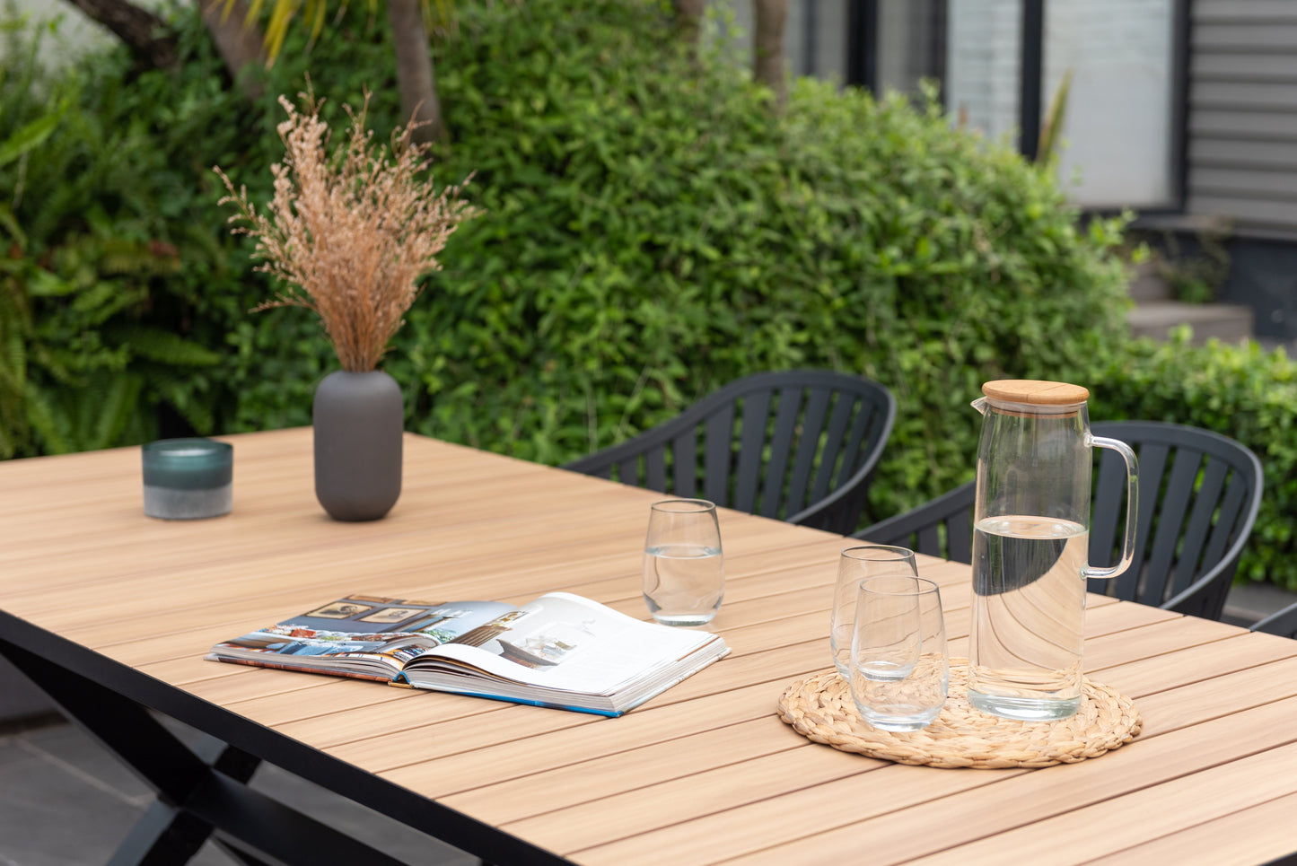 Panama dark rectangular table and 6 Nassau black aluminum dining chairs on patio on Tampa Home & Garden Store