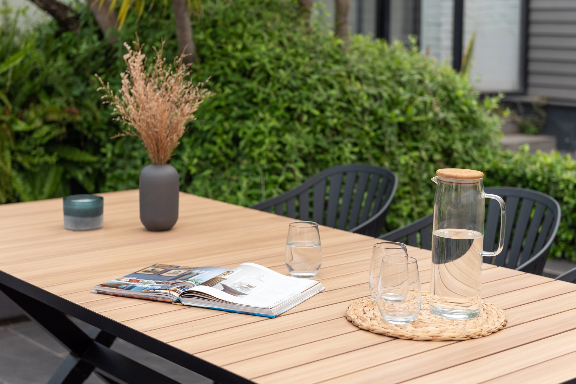 Panama dark rectangular table and 6 Nassau black aluminum dining chairs on patio on Tampa Home & Garden Store